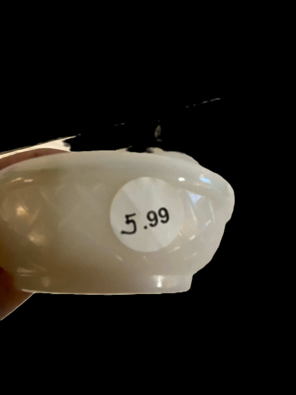 Hand Holding a White Bowl with a Price Tag